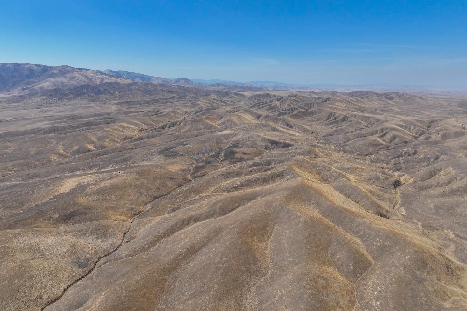 0 County Road 8335 Firebaugh, CA 93622 - Photo 4 of 6 a view of a dry yard with mountains in the background