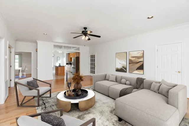 a living room with furniture and a wooden floor