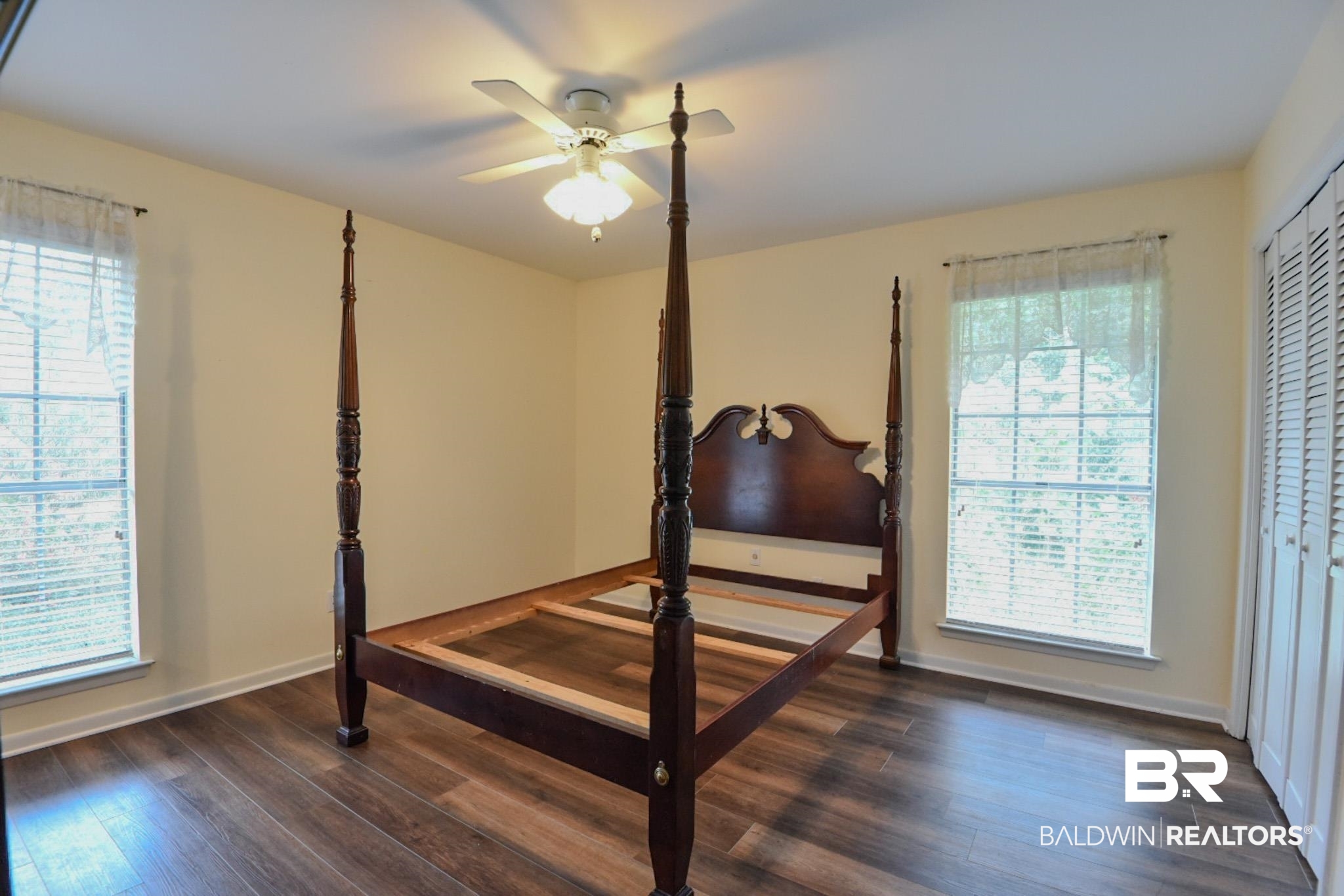 90 Paddock Drive Fairhope, AL 36532 - Photo 15 of 23 Bedroom featuring dark wood-type flooring, multiple windows, and a ceiling fan