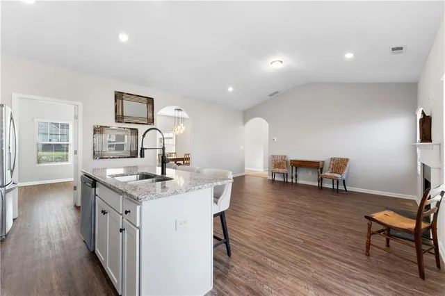 a kitchen with a sink cabinets and wooden floor