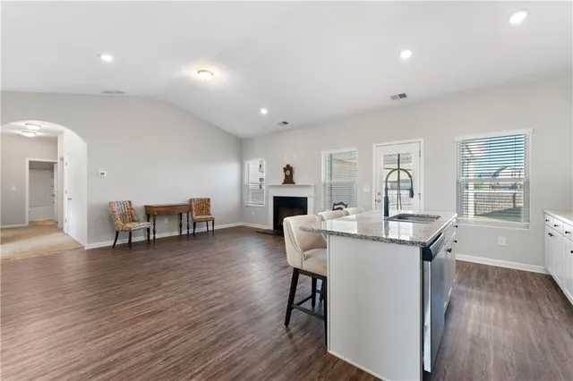 a view of a kitchen with furniture and wooden floor