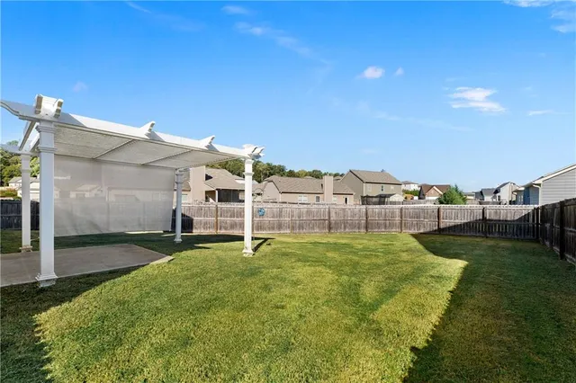 a swimming pool with a yard in the back
