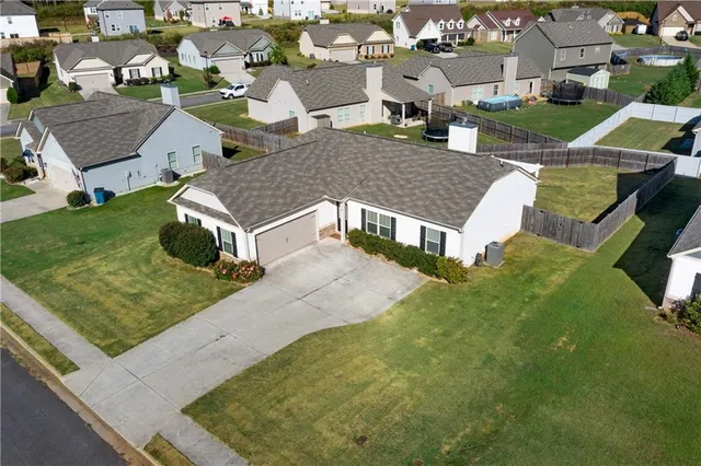 an aerial view of multiple houses with yard