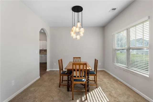 a view of a dining room with furniture and a window