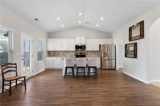 a view of kitchen with refrigerator microwave and wooden floor