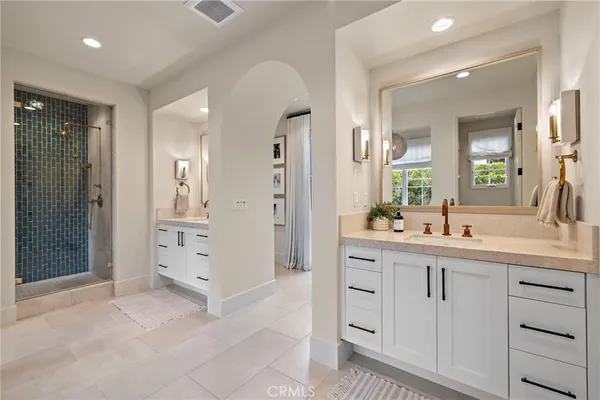 a spacious bathroom with a granite countertop sink mirror and shower