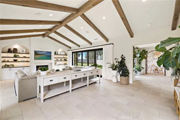 a large white bedroom with furniture and white walls