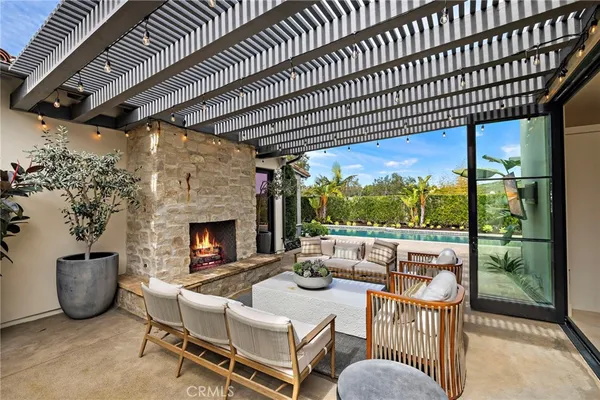 a view of a patio with a table chairs and a fireplace