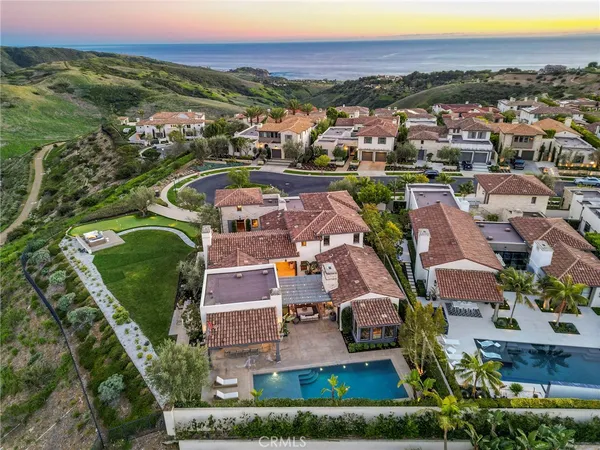 an aerial view of residential houses with outdoor space and river