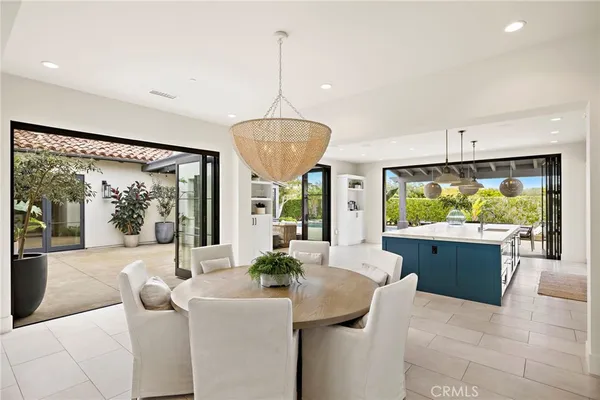 a living room with furniture a large window and dining table