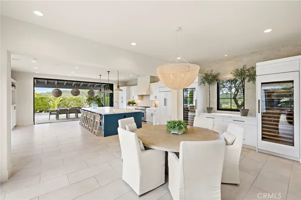 a dining hall with stainless steel appliances kitchen island granite top and stove