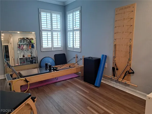 a room with wooden floor and windows