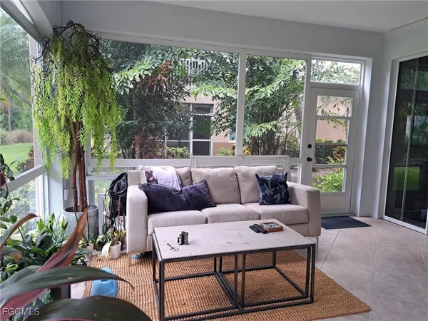 a living room with furniture and a potted plant