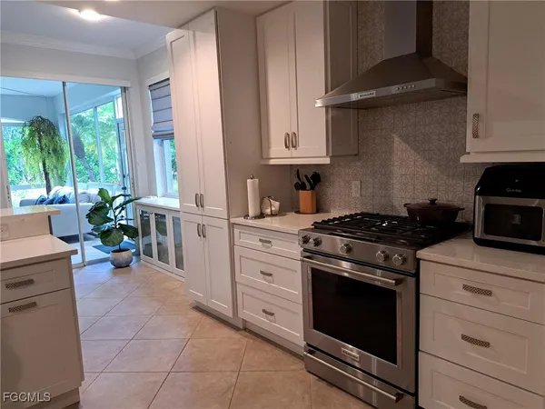 a kitchen with stainless steel appliances white cabinets and a stove