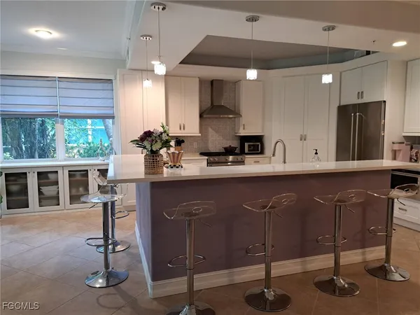 a kitchen with a sink cabinets and window