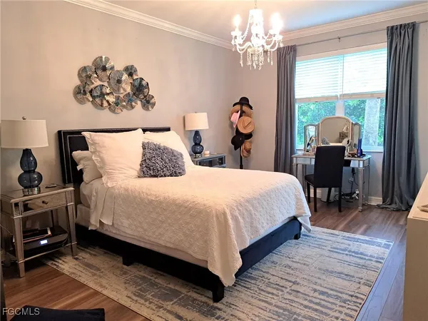 a bedroom with a bed and a chandelier