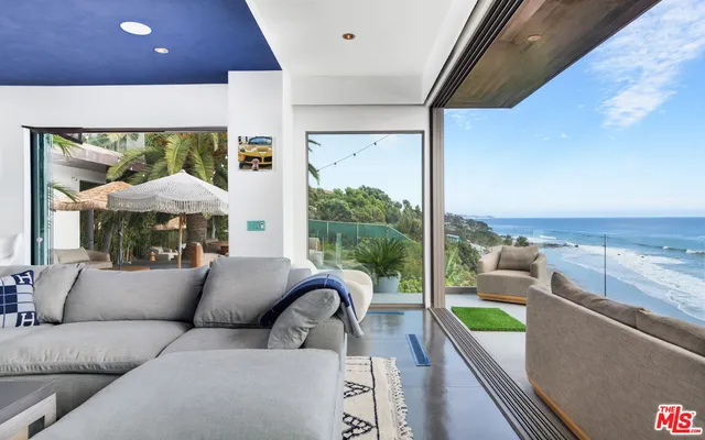 a balcony with furniture and a floor to ceiling window