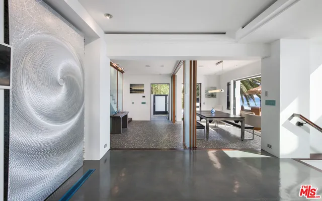 a room with pool table and windows