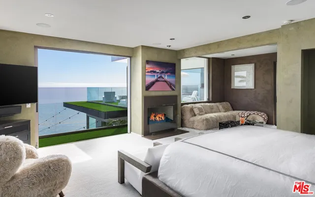 a bedroom with furniture and a flat screen tv