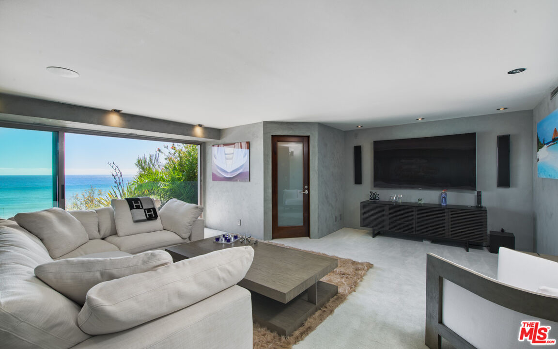 33406 Pacific Coast Highway Malibu, CA 90265 - Photo 23 of 51 a living room with furniture and a flat screen tv