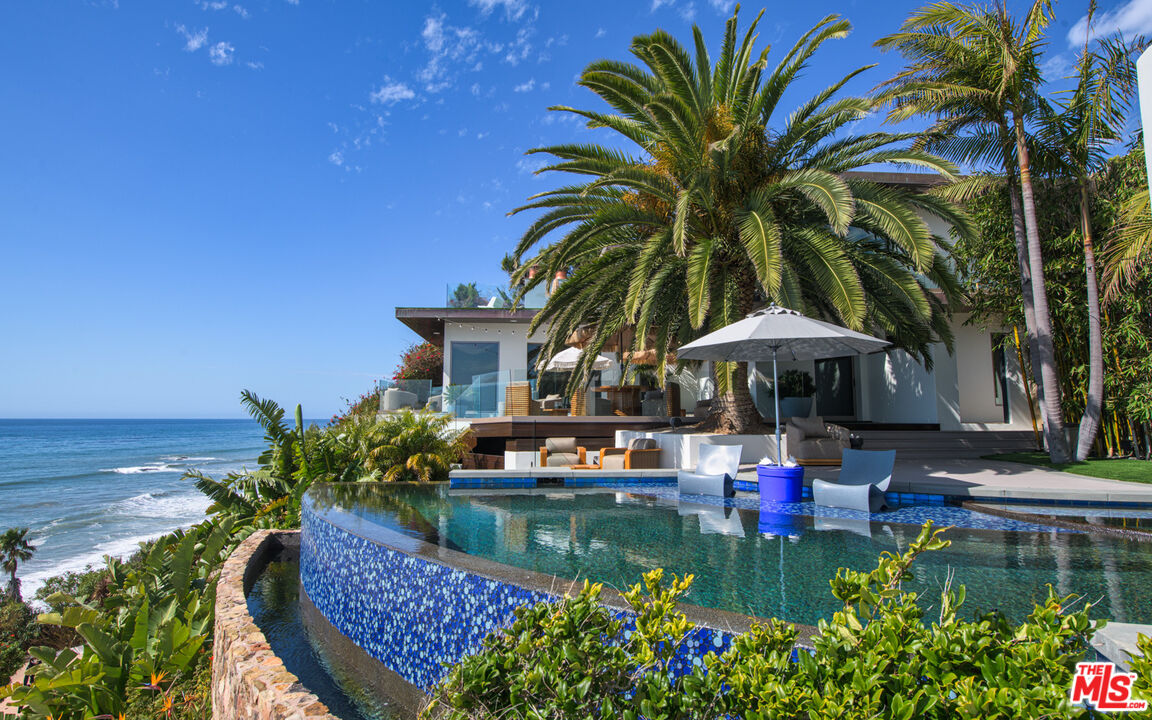 33406 Pacific Coast Highway Malibu, CA 90265 - Photo 27 of 51 a view of a house with pool and chairs
