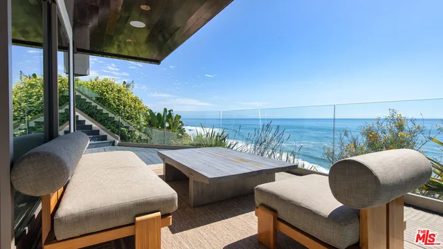 a couple of chairs sitting in backyard of the house