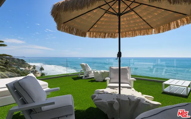 a view of a two chairs in the garden