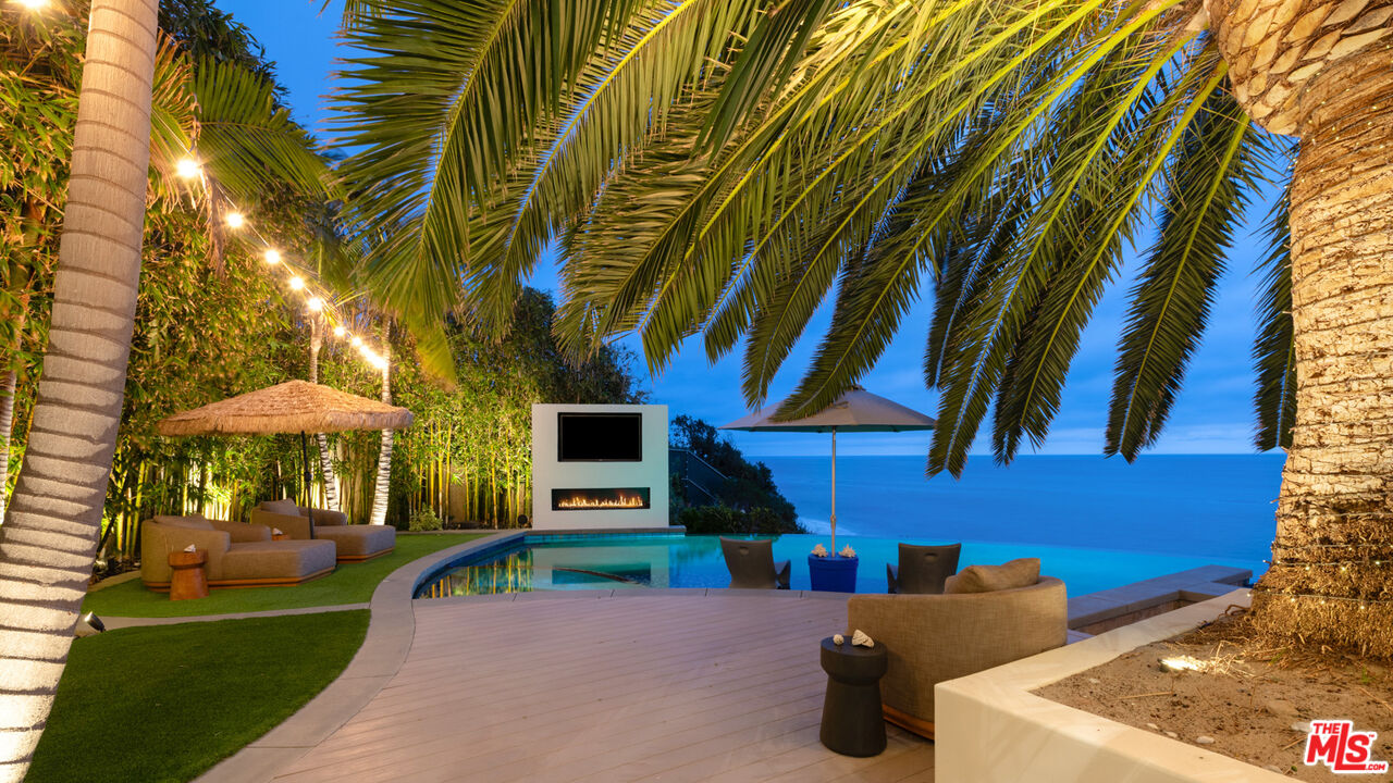 33406 Pacific Coast Highway Malibu, CA 90265 - Photo 43 of 51 a backyard of a house with barbeque oven table and chairs