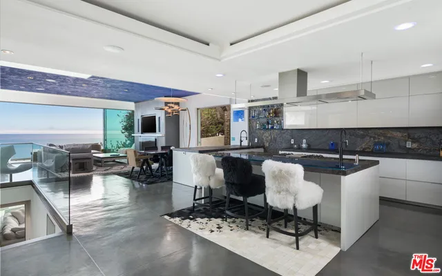 a large kitchen with a table and chairs