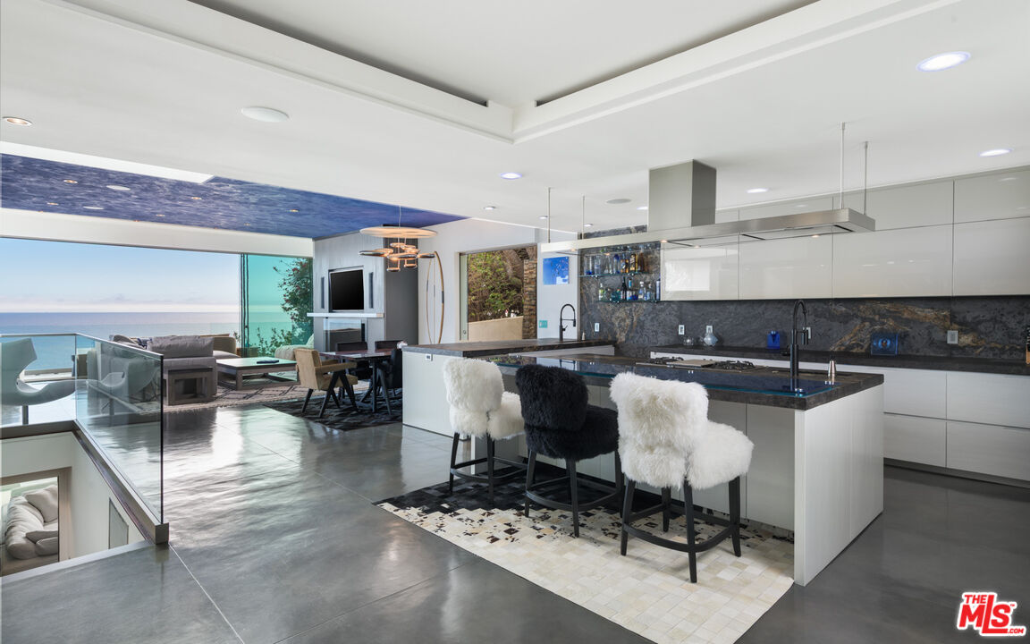 33406 Pacific Coast Highway Malibu, CA 90265 - Photo 9 of 51 a large kitchen with a table and chairs