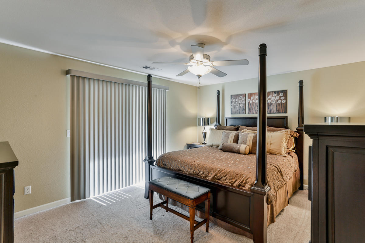 7502 Pit Road Redding, CA 96001 - Photo 11 of 26 a bedroom with a bed and a chandelier