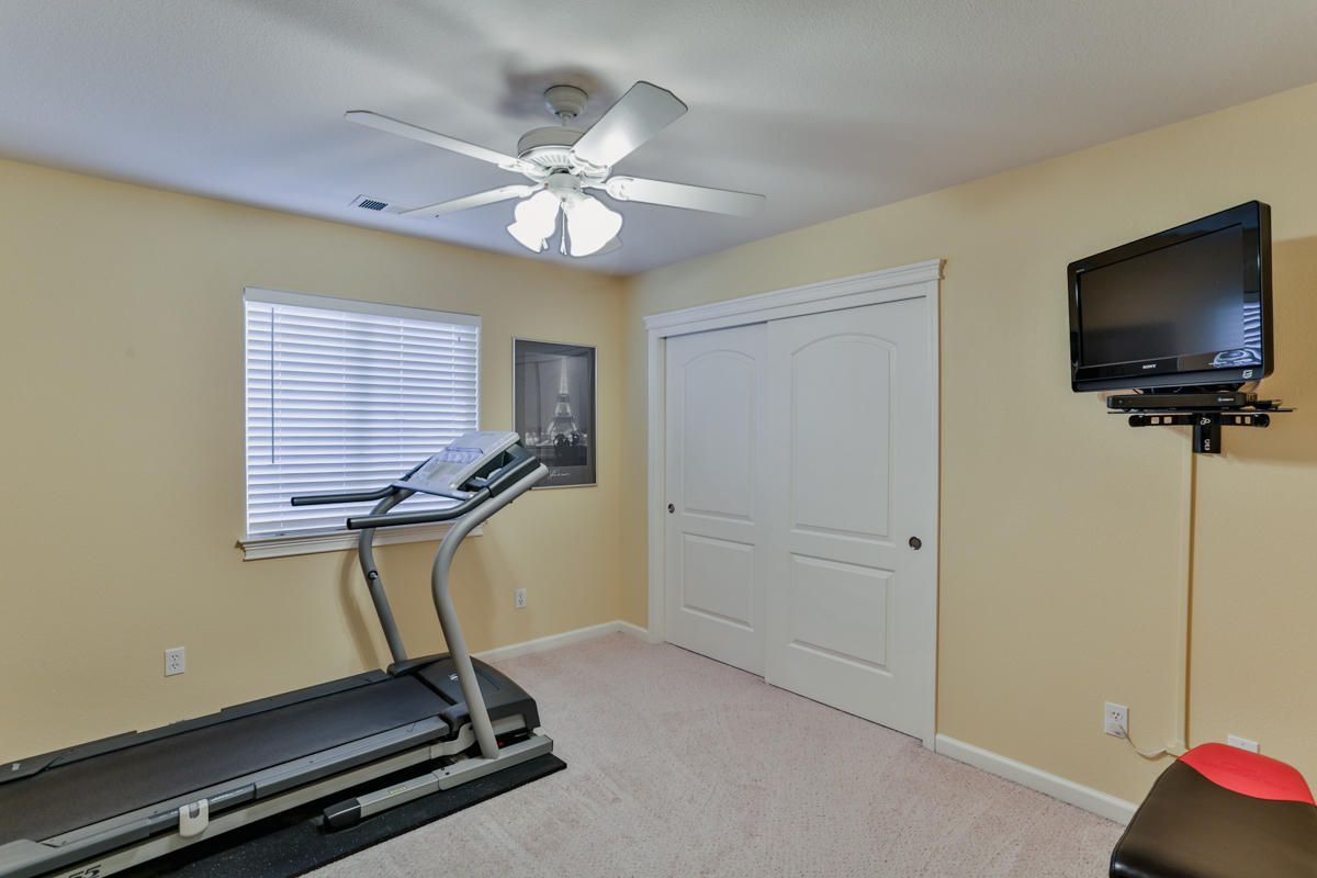7502 Pit Road Redding, CA 96001 - Photo 16 of 26 a room with gym equipment and a flat screen tv