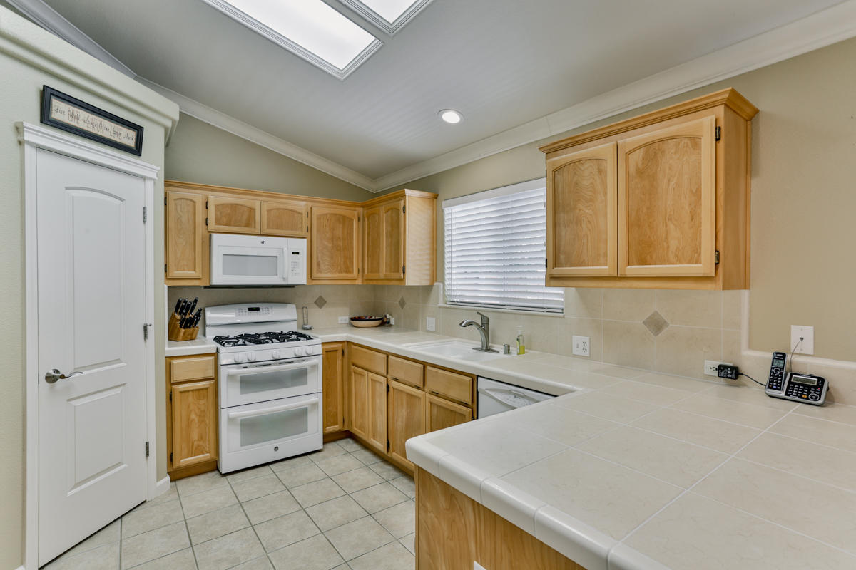 7502 Pit Road Redding, CA 96001 - Photo 9 of 26 a kitchen with a stove a sink and a refrigerator