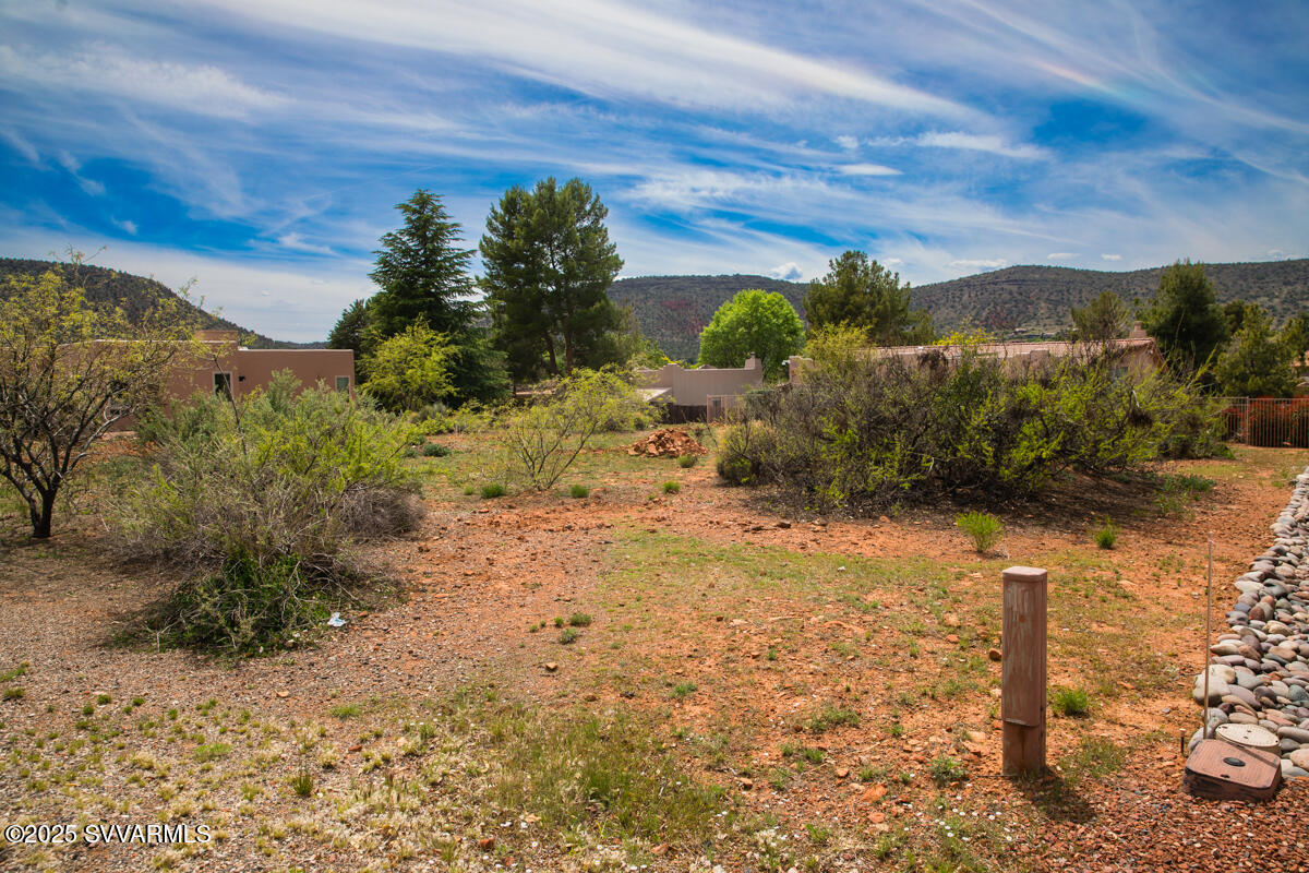 26 South House Rock Road, Unit 43 Sedona, AZ 86351 - Photo 8 of 15 a view of a yard with plants and a bench