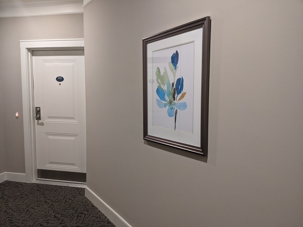 70 Trotter Road, Unit 312 Weymouth, MA 02190 - Photo 6 of 18 a view of elevator with wooden floor