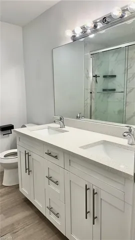 a bathroom with a sink double vanity and a mirror