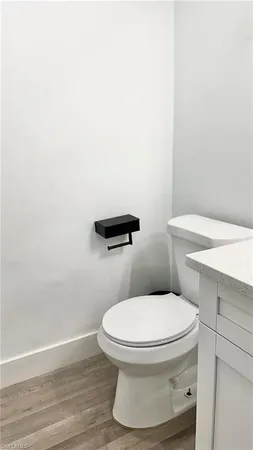 a white toilet sitting next to a bathroom sink