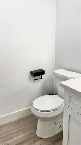 a white toilet sitting next to a bathroom sink