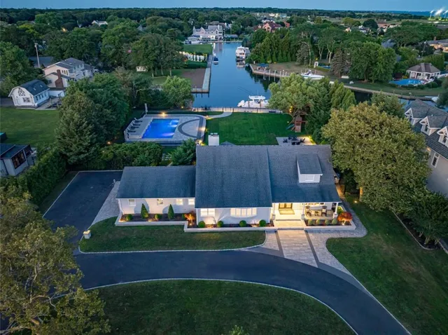 an aerial view of a house with yard swimming pool and outdoor seating