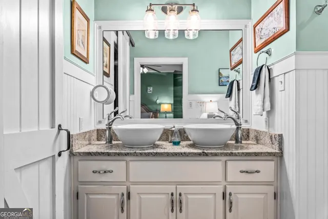 a bathroom with a granite countertop sink and a bathtub
