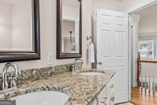 a view of walk in closet with window and wooden floor