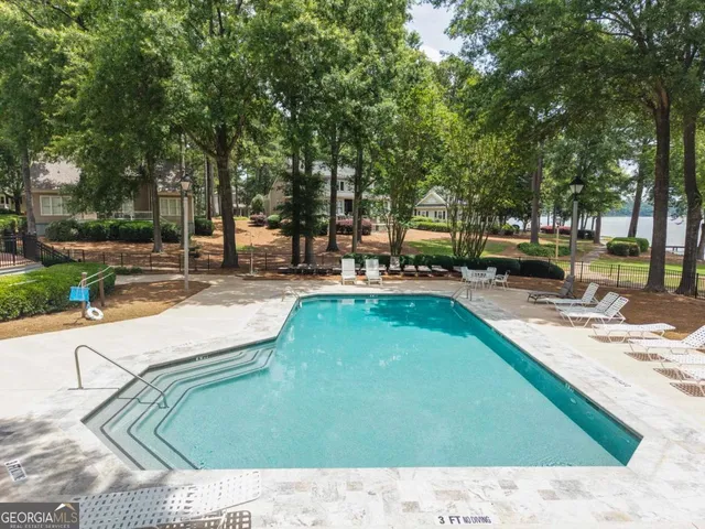 an aerial view of house with yard swimming pool and outdoor seating