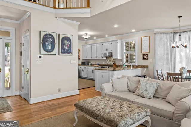 a living room with furniture and kitchen view