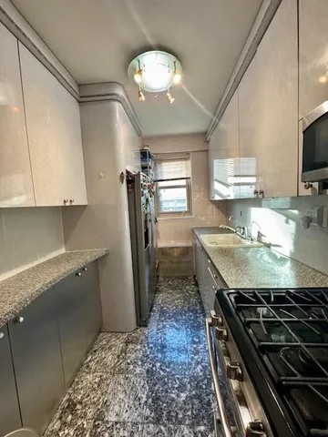 a en suite bathroom with a shower and a sink