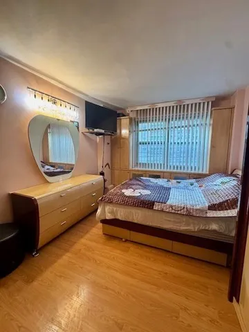 a living room with a bed furniture and a large window