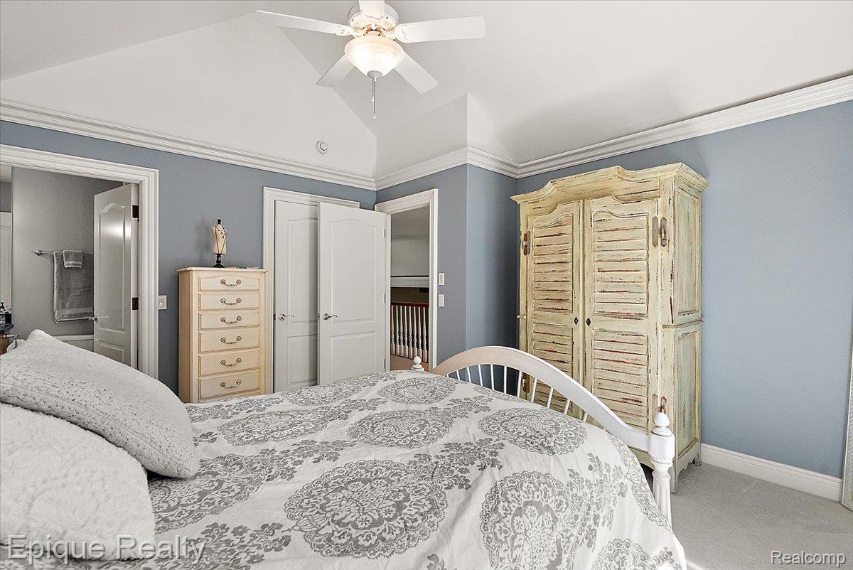 7662 Devins Ridge Clarkston, MI 48348 - Photo 68 of 81 Vaulted ceiling with a ceiling fan, crown molding, double paneled doors, and light gray wall paint