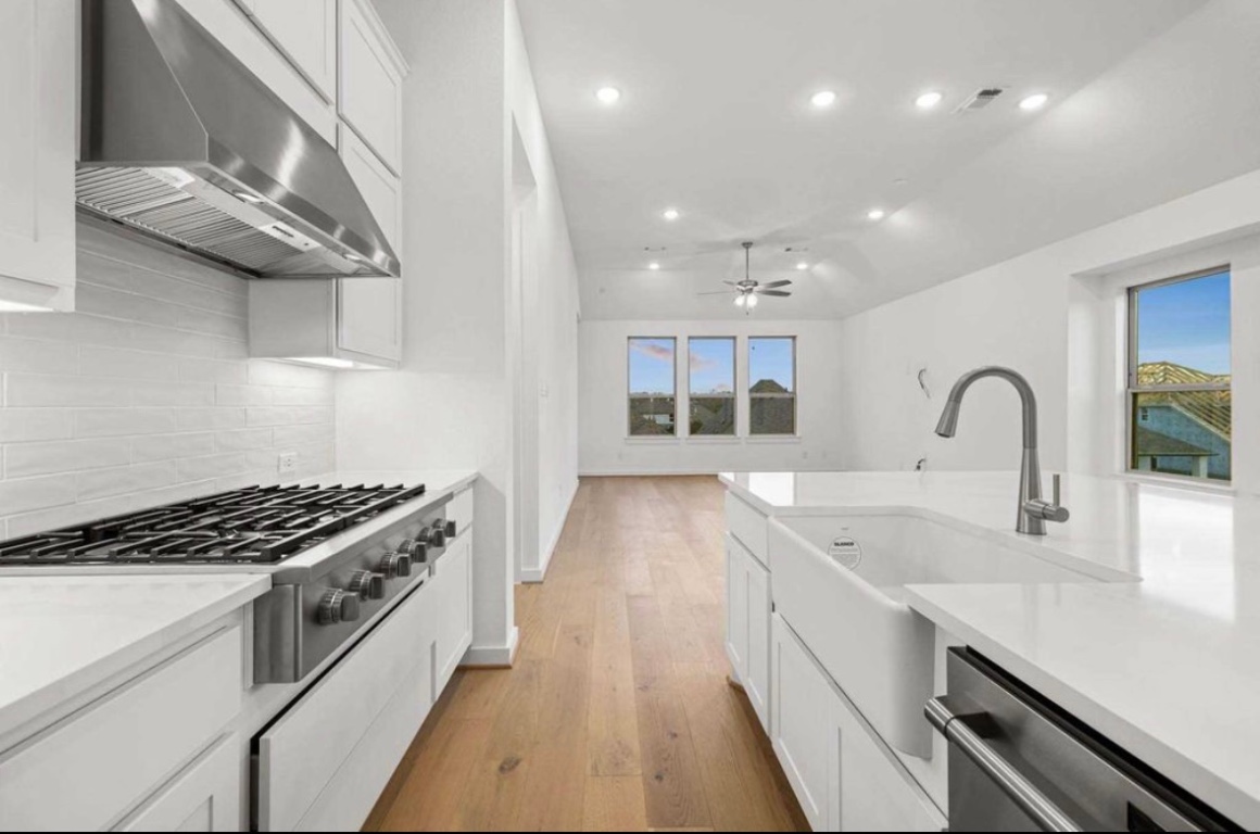 1116 Addison Lane Georgetown, TX 78628 - Photo 13 of 17 a kitchen with stainless steel appliances granite countertop a sink stove and cabinets