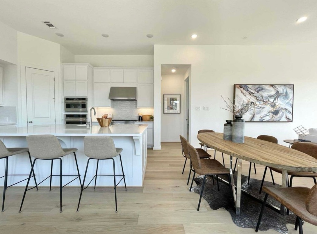 1116 Addison Lane Georgetown, TX 78628 - Photo 2 of 17 a view of a dining room with furniture and wooden floor