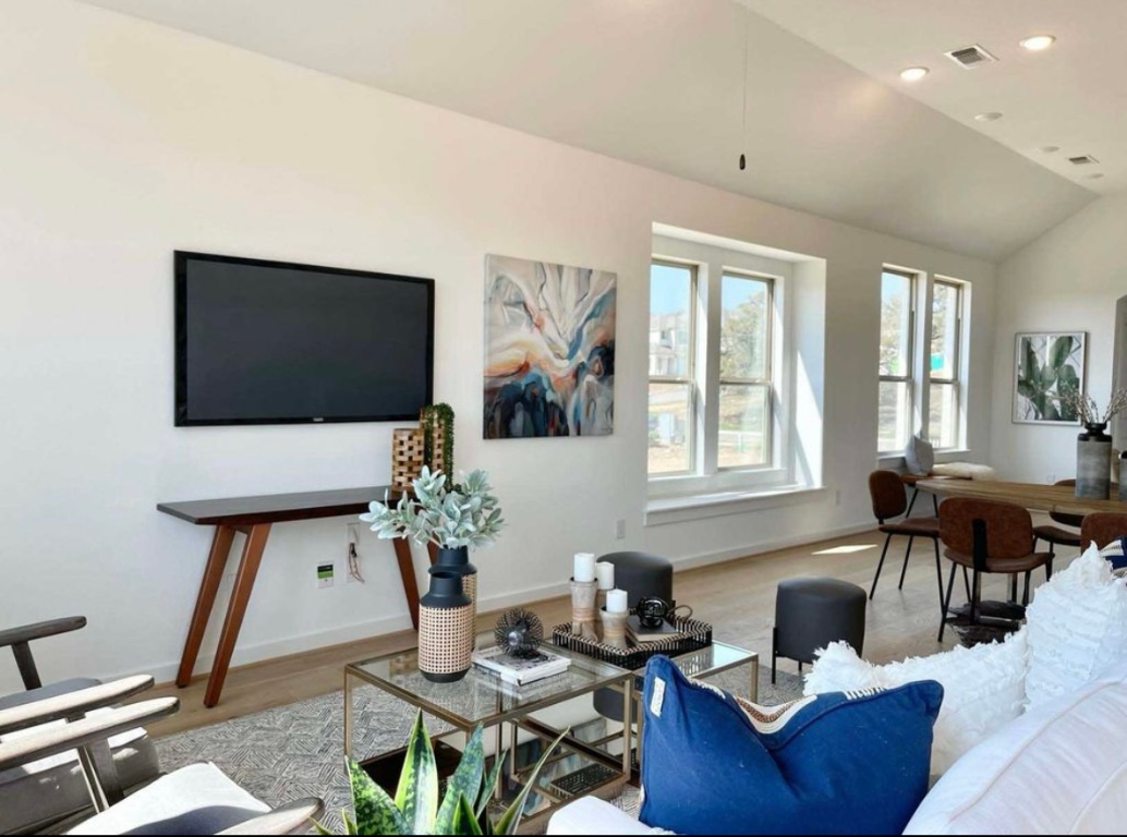 1116 Addison Lane Georgetown, TX 78628 - Photo 6 of 17 a living room with furniture a flat screen tv and a floor to ceiling window