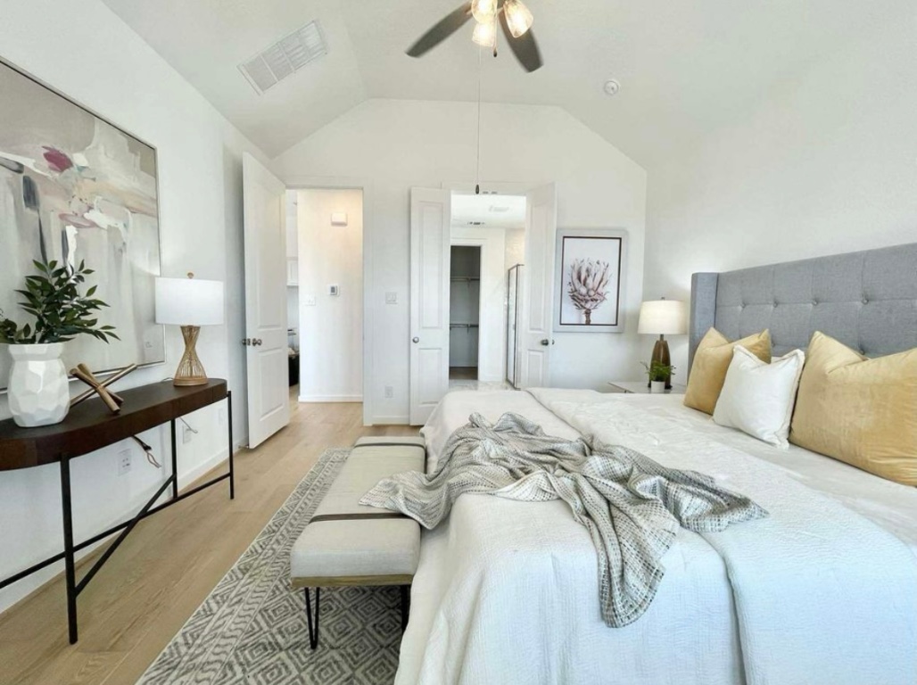 1116 Addison Lane Georgetown, TX 78628 - Photo 8 of 17 a bedroom with a bed and a chandelier